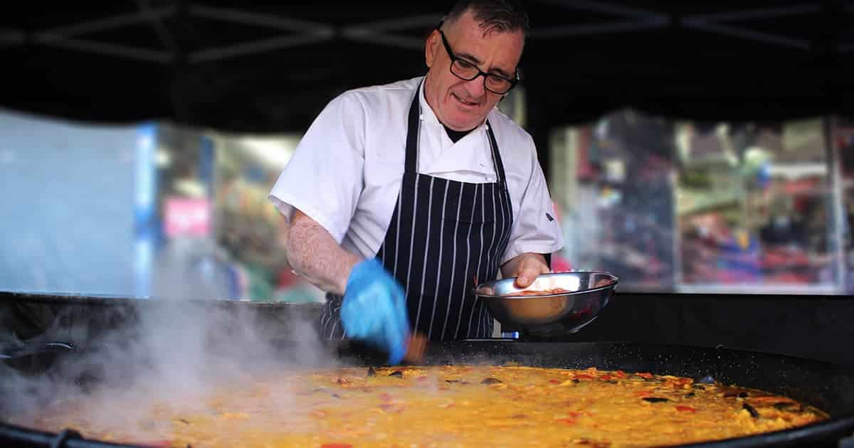 A man preparing Paella