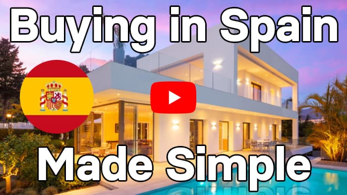 Luxury house with a pool in Spain by night with "Buying in Spain Made Simple" written