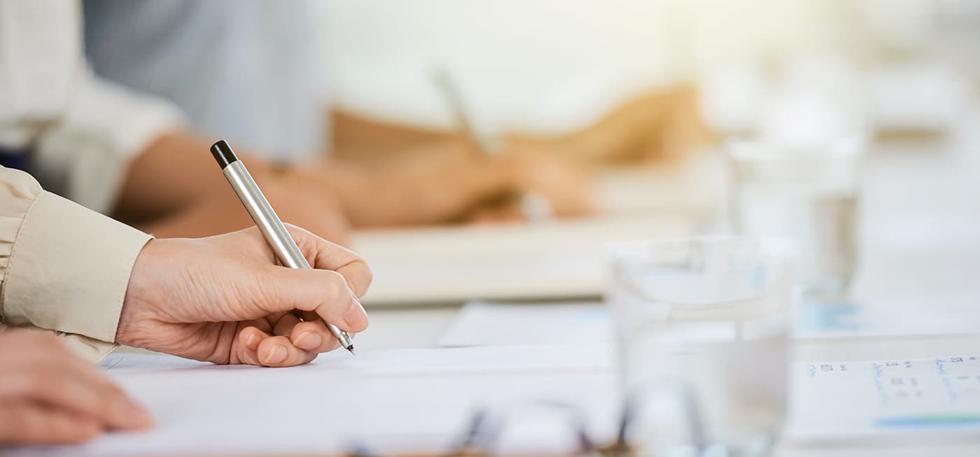 Someone signing a document