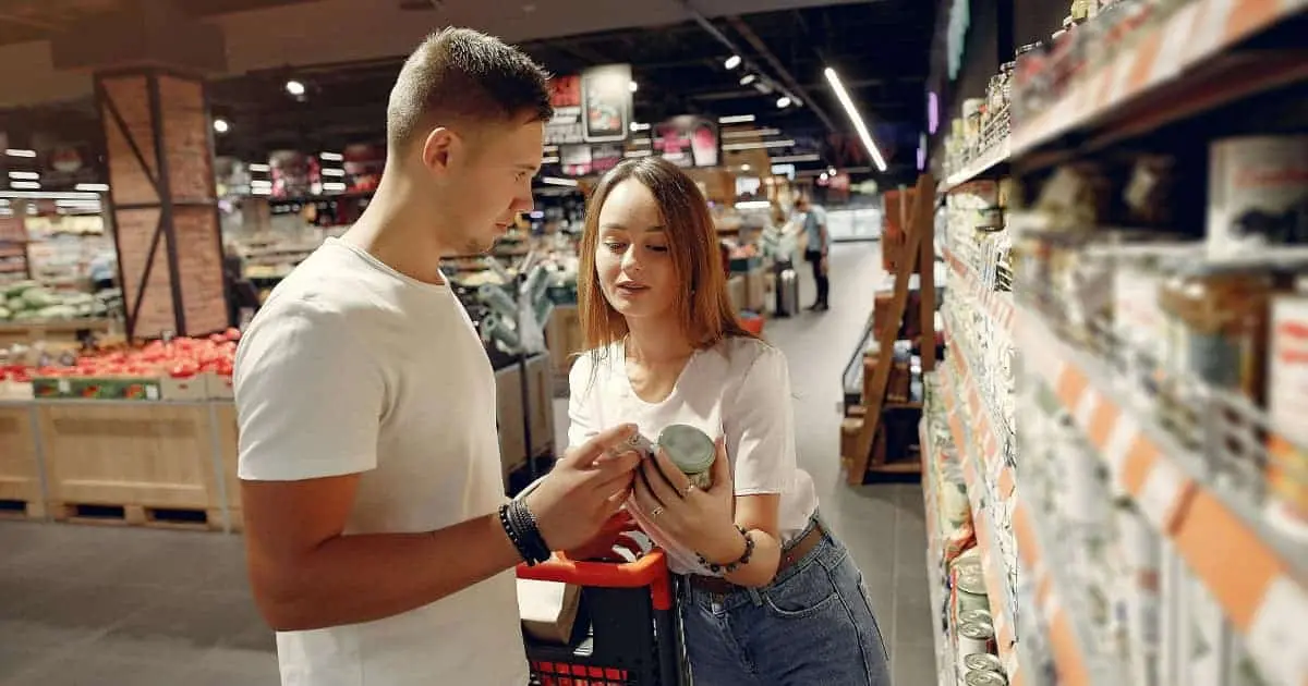 Young couple shopping in a supermarket in Spain, illustrating cost of living and grocery expenses