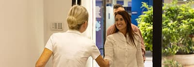 Woman greeting visitors