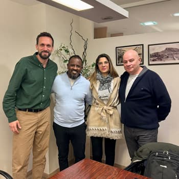 A real estate hunter with a couple and the former owner at the notary’s office after purchasing a property in Spain