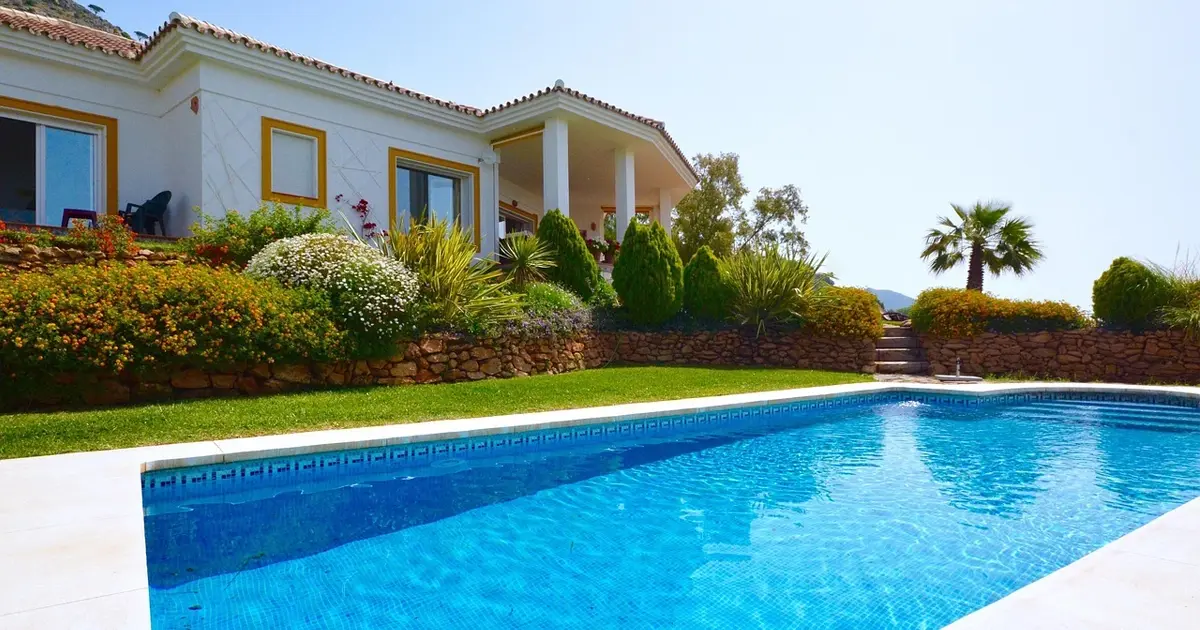 Luxury villa in Spain with a private swimming pool and landscaped garden under sunny blue skies