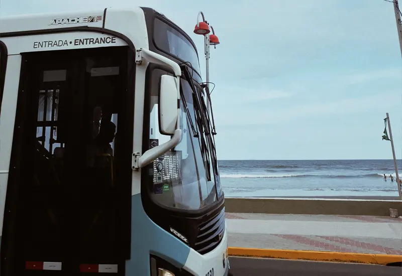 Bus in Spain driving along the seaside, representing cost of living and public transport expenses