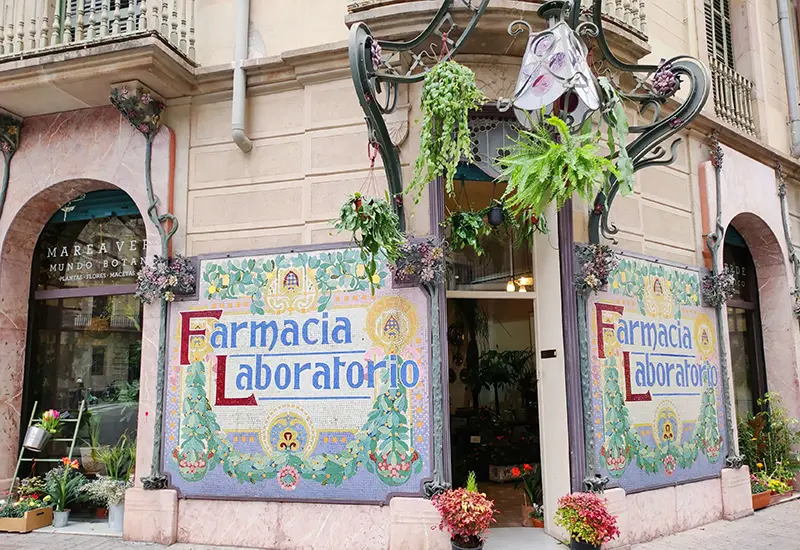 Colorful pharmacy facade in Spain, symbolizing healthcare and medicine costs