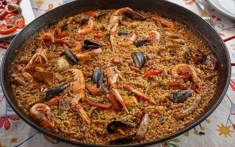 Seafood paella with prawns, mussels and saffron rice, iconic traditional dish of Spain