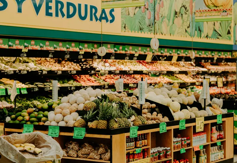 Fruit and vegetable section in a Spanish supermarket, reflecting daily grocery expenses
